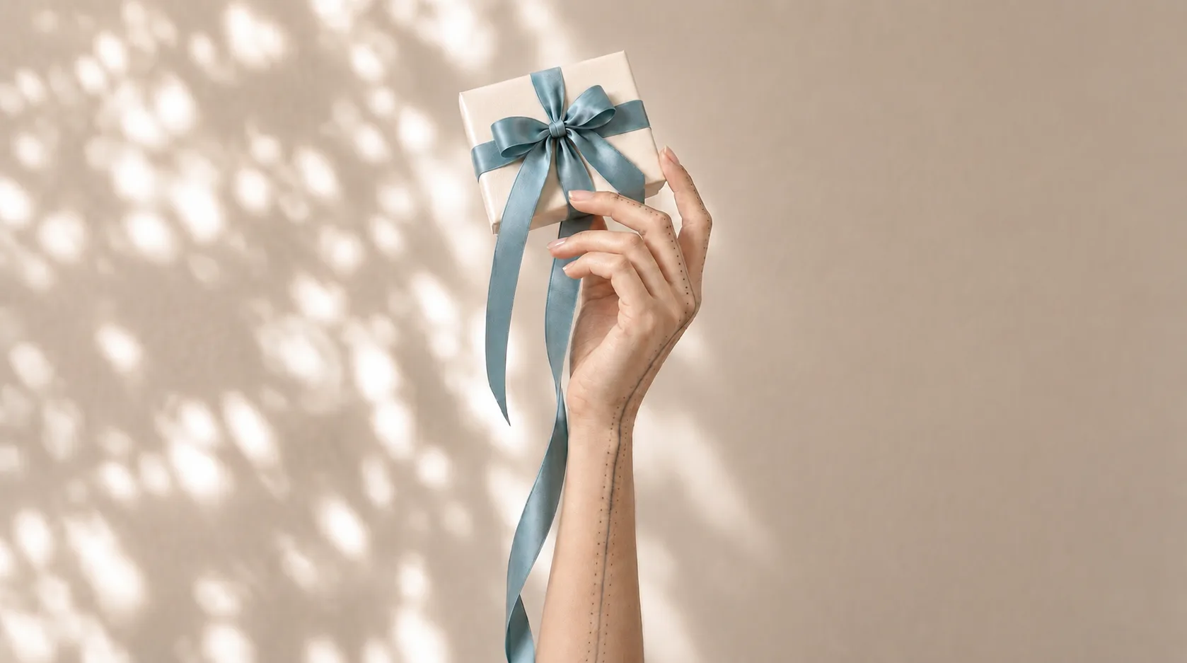 Gift box with a blue ribbon, offer a cranio-sacral treatment